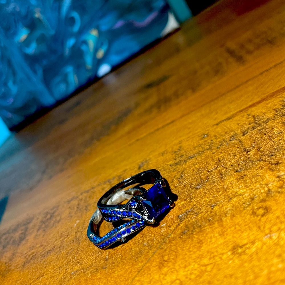 Tinted black band, with blue gems, 2 piece ring.